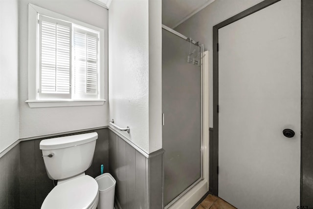 bathroom featuring walk in shower and toilet