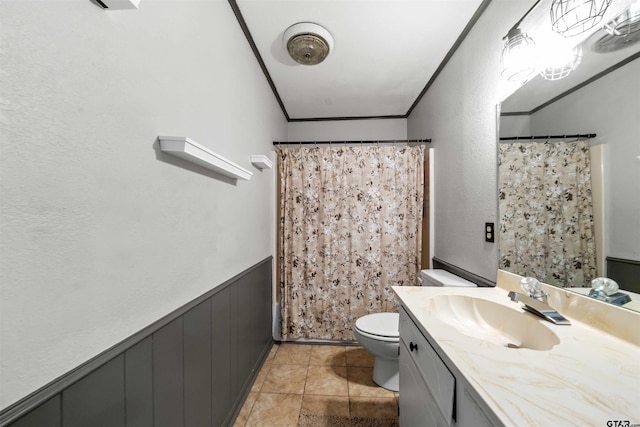 bathroom with toilet, tile patterned flooring, curtained shower, vanity, and crown molding