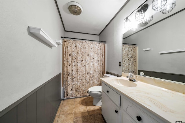 full bathroom with toilet, vanity, ornamental molding, and tile patterned floors