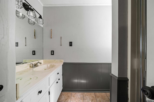 bathroom with vanity, wooden walls, tile patterned flooring, and crown molding