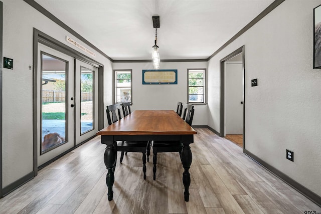 dining area featuring light hardwood / wood-style flooring, french doors, and ornamental molding