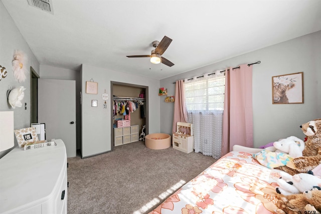 carpeted bedroom with a closet, washer / clothes dryer, and ceiling fan