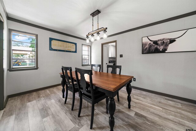 dining room featuring hardwood / wood-style floors and crown molding