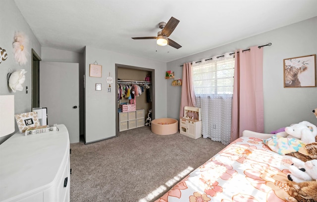 bedroom featuring light colored carpet, ceiling fan, and a closet