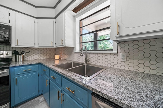 kitchen with blue cabinets, decorative backsplash, and stainless steel electric stove