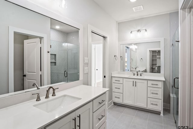 bathroom featuring vanity, tile patterned floors, and a shower with door