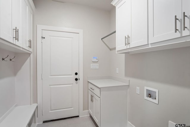 washroom with cabinets and washer hookup