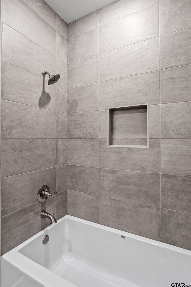 bathroom with tiled shower / bath combo