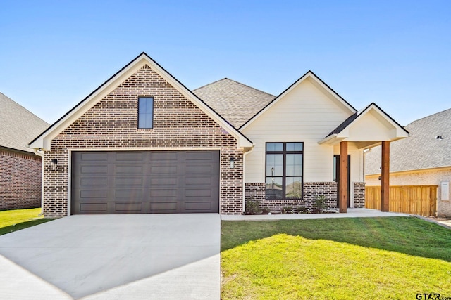 view of front of house with a garage and a front yard