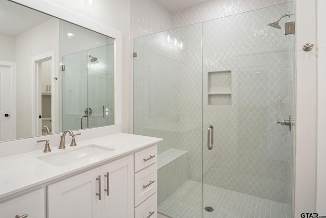 bathroom featuring an enclosed shower and vanity