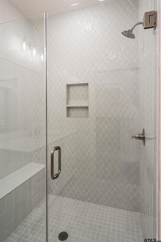 bathroom featuring a shower with door