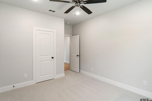 unfurnished bedroom featuring light carpet and ceiling fan