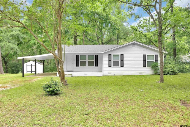 manufactured / mobile home featuring an outdoor structure, a carport, a storage shed, crawl space, and a front lawn