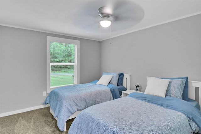 bedroom featuring baseboards, a ceiling fan, carpet floors, and crown molding
