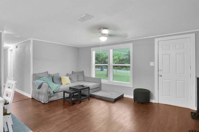 living room featuring visible vents, wood finished floors, a ceiling fan, and crown molding