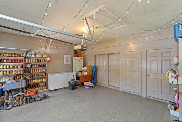 garage with a garage door opener and fridge