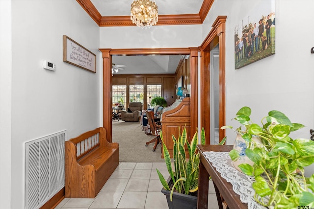 corridor featuring a chandelier, light colored carpet, and crown molding