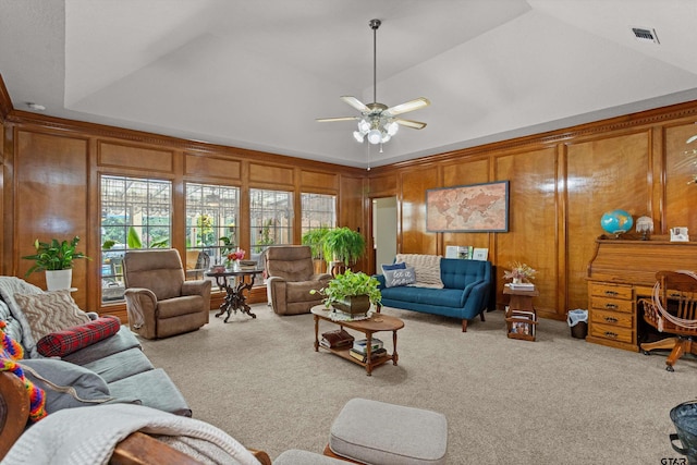 living room featuring wooden walls, vaulted ceiling, light carpet, and ceiling fan