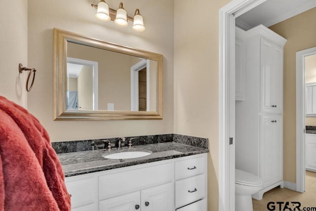 bathroom with tile patterned floors, vanity, and toilet