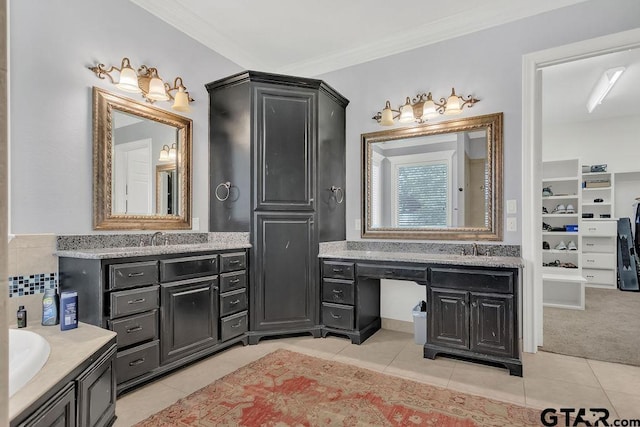 bathroom featuring tile patterned floors, vanity, and crown molding