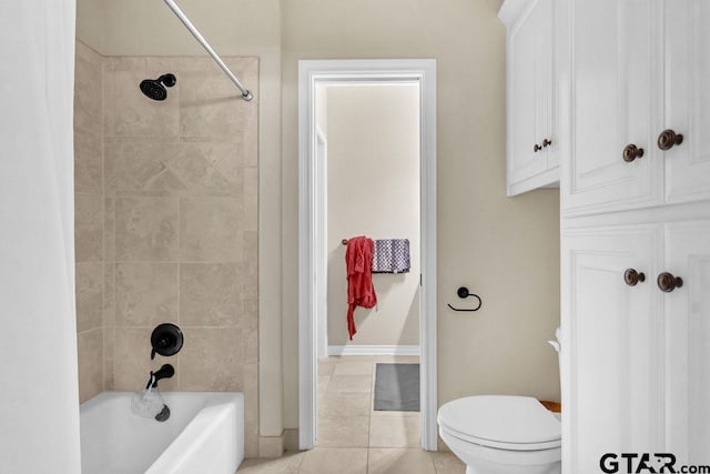 bathroom featuring toilet, tile patterned floors, and tiled shower / bath