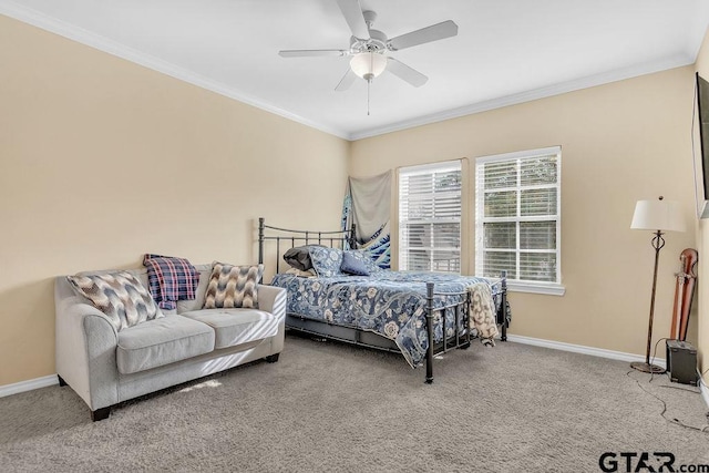 carpeted bedroom featuring ceiling fan and crown molding