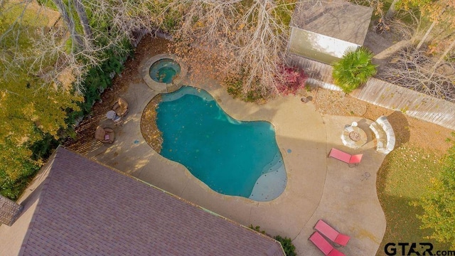 view of pool featuring an in ground hot tub