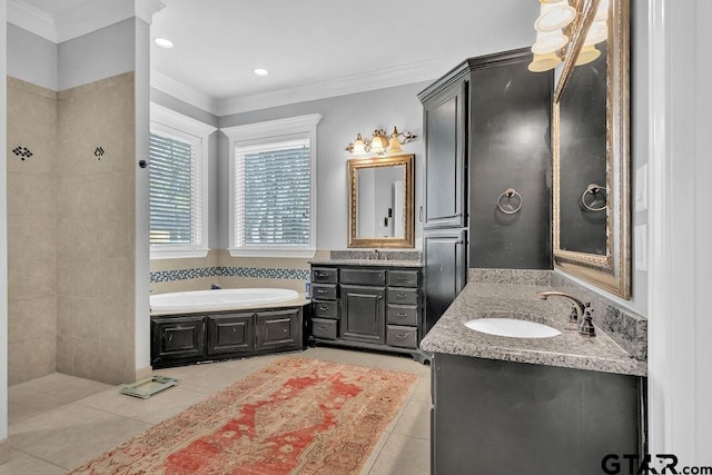 bathroom featuring tile patterned flooring, vanity, a tub, and crown molding