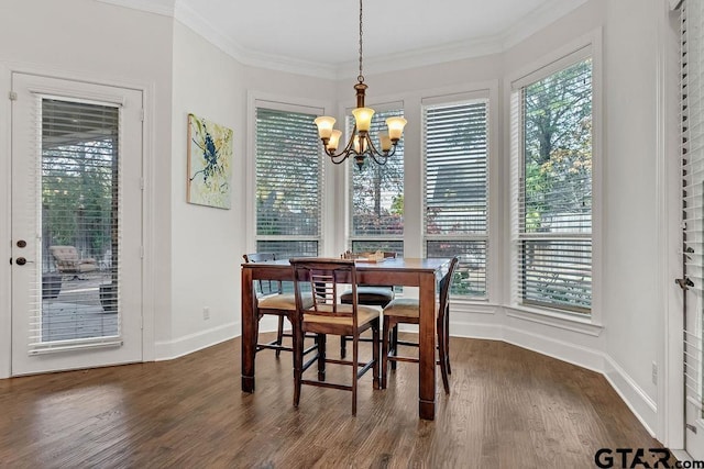 dining space featuring a notable chandelier, dark hardwood / wood-style flooring, and crown molding