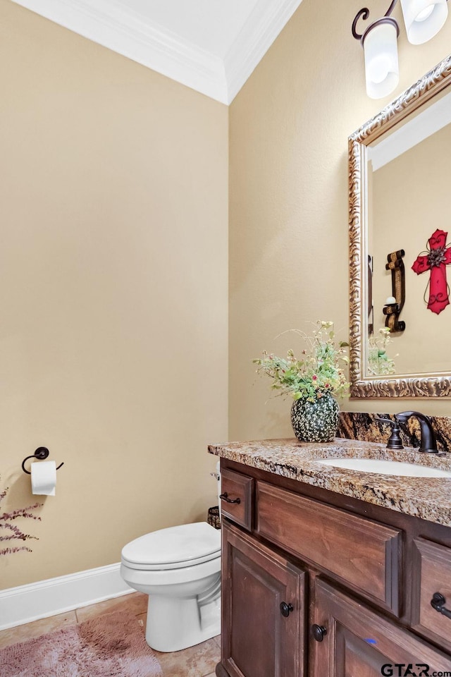 bathroom with tile patterned flooring, vanity, toilet, and crown molding