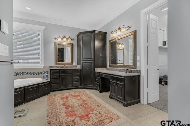 bathroom featuring a washtub, vanity, tile patterned floors, and ornamental molding