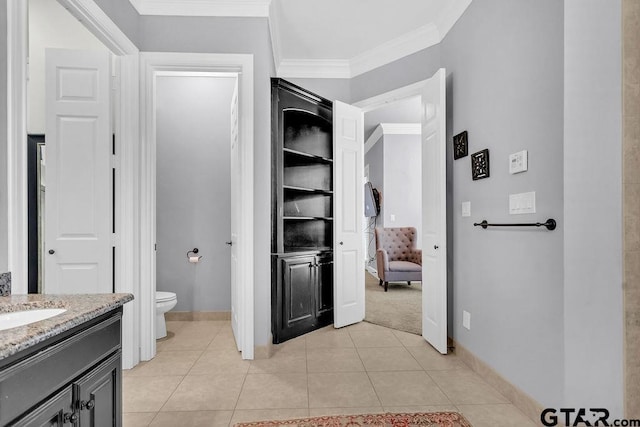 bathroom with tile patterned floors, vanity, toilet, and crown molding