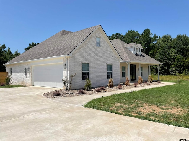 view of front of house featuring a garage and a front lawn