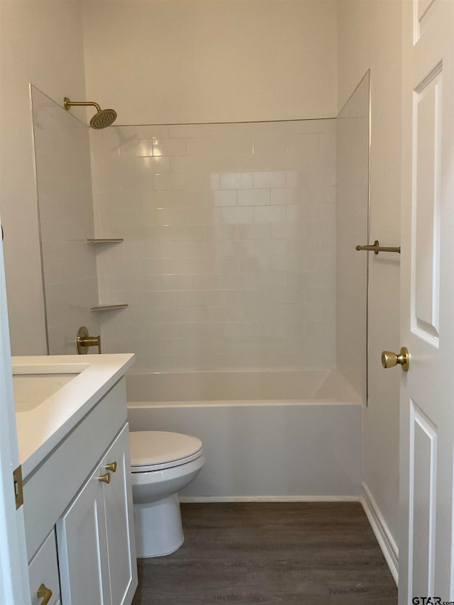 full bathroom with toilet, vanity, hardwood / wood-style floors, and tiled shower / bath