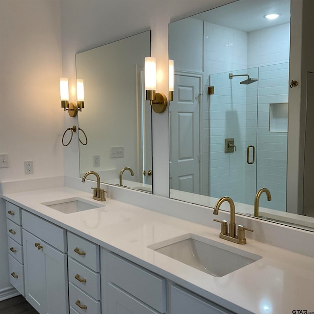 bathroom with vanity and a shower with door