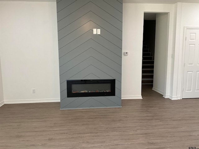 room details with hardwood / wood-style floors and a fireplace