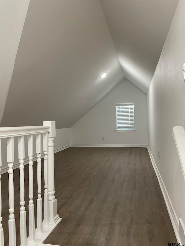 bonus room with dark wood-type flooring and lofted ceiling