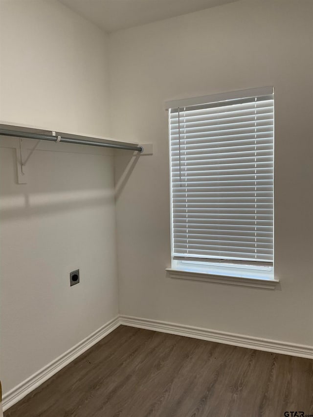 washroom featuring dark wood-type flooring and electric dryer hookup