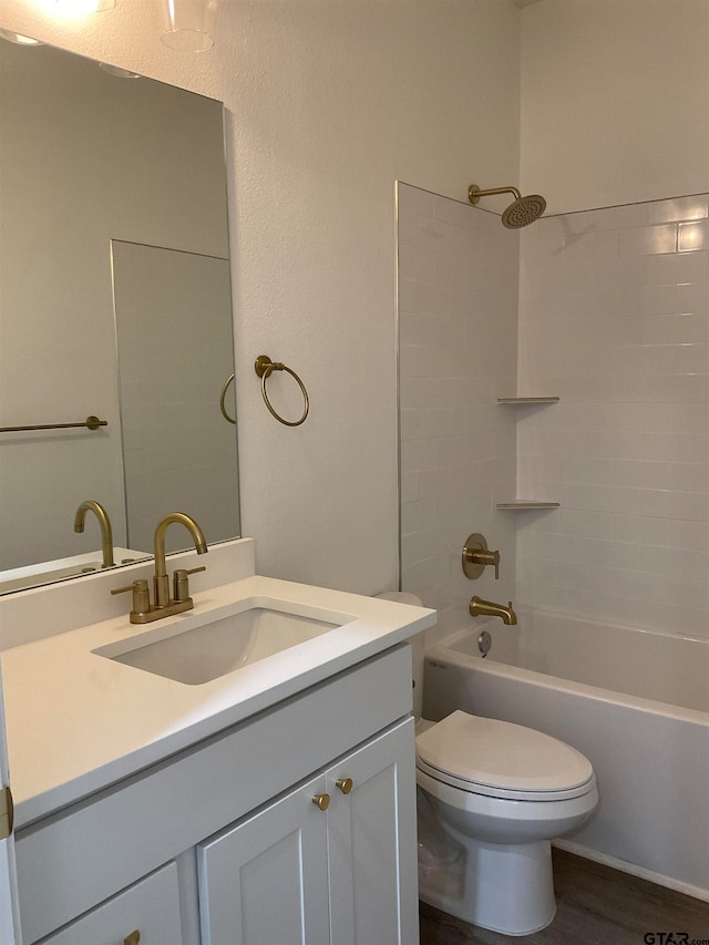 full bathroom featuring hardwood / wood-style flooring, vanity, toilet, and shower / bath combination