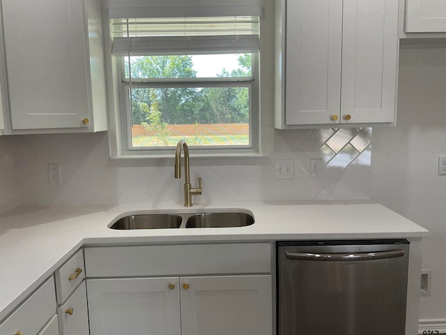 kitchen with white cabinets, decorative backsplash, stainless steel dishwasher, and sink