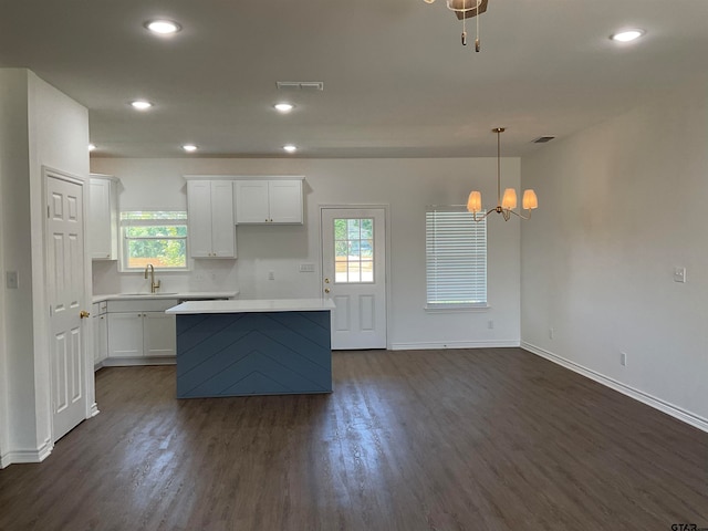 kitchen with white cabinetry, a wealth of natural light, dark hardwood / wood-style floors, and decorative light fixtures