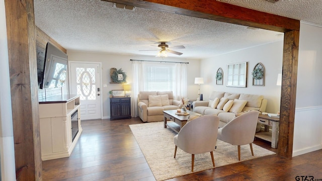 living room with dark wood-type flooring, ceiling fan, and a textured ceiling