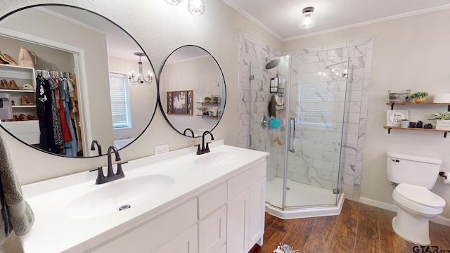 bathroom featuring a shower with door, a chandelier, hardwood / wood-style flooring, vanity, and crown molding