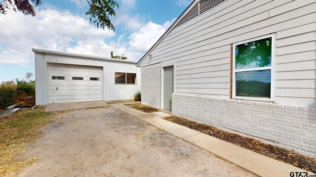 9497 Fm 804, Larue, TX 75770 - view of side of home with an outdoor structure, driveway, and brick siding