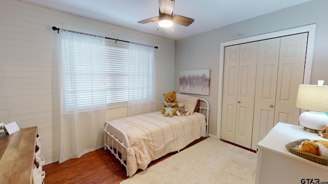 bedroom featuring hardwood / wood-style flooring, ceiling fan, and a closet