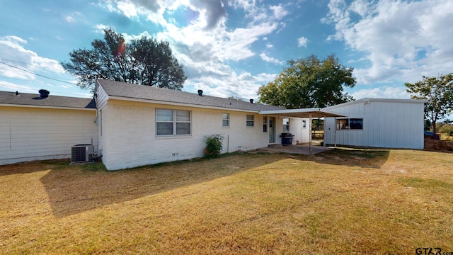 back of house with central AC unit, a patio, and a yard