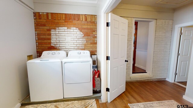 9497 Fm 804, Larue, TX 75770 - washroom with washing machine and clothes dryer and wood finished floors