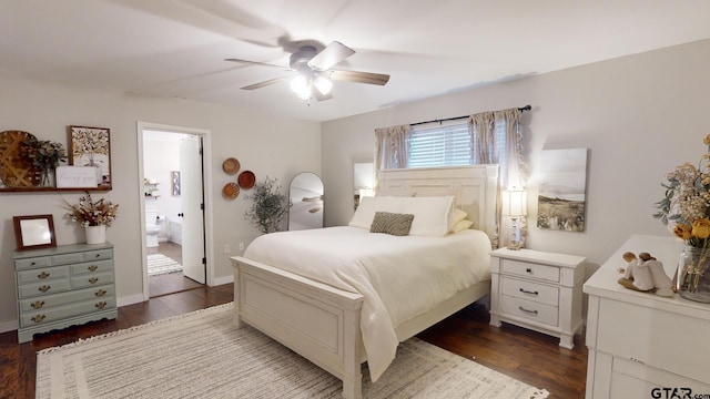 bedroom with ensuite bath, ceiling fan, and dark hardwood / wood-style flooring