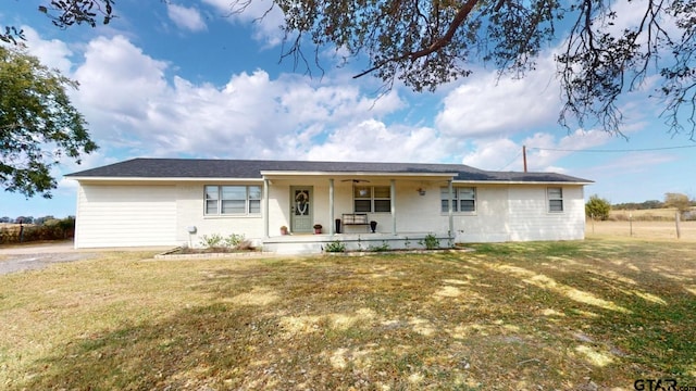 ranch-style house featuring a front lawn and covered porch