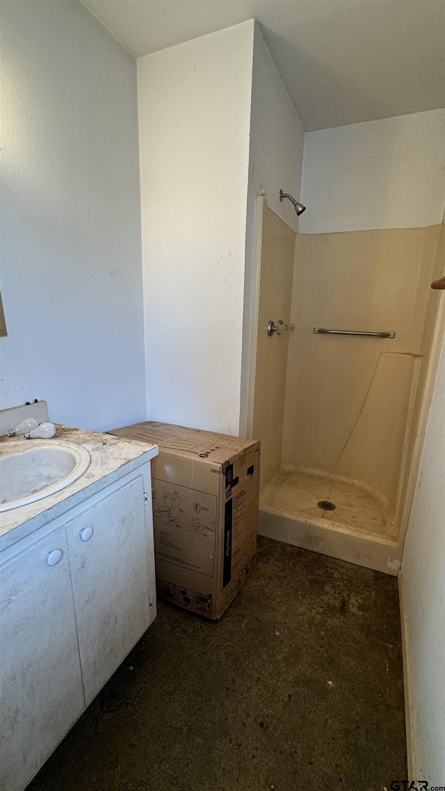 bathroom with walk in shower and vanity